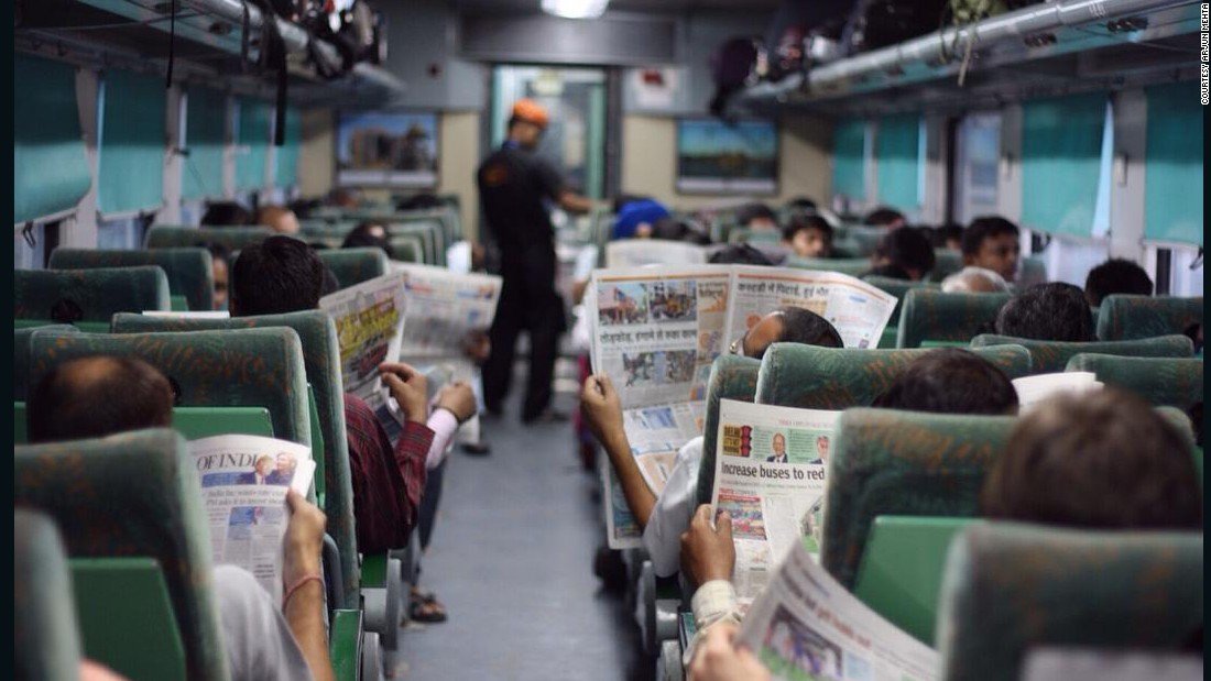 150929131057-reading-newspapers-on-train-india-super-169