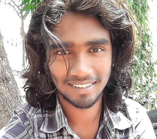 A-photograph-of-an-Indian-male-with-beautiful-long-wavy-hair-reaching-his-shoulders